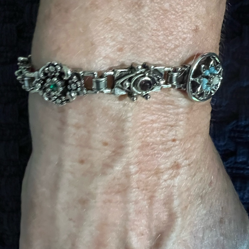 I love this vintage bracelet with so many stones and filigree of flowers.
